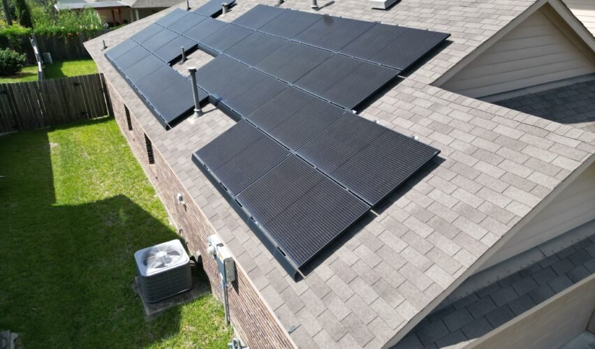 Aerial view of suburban homes in a residential neighborhood with solar panels on rooftop