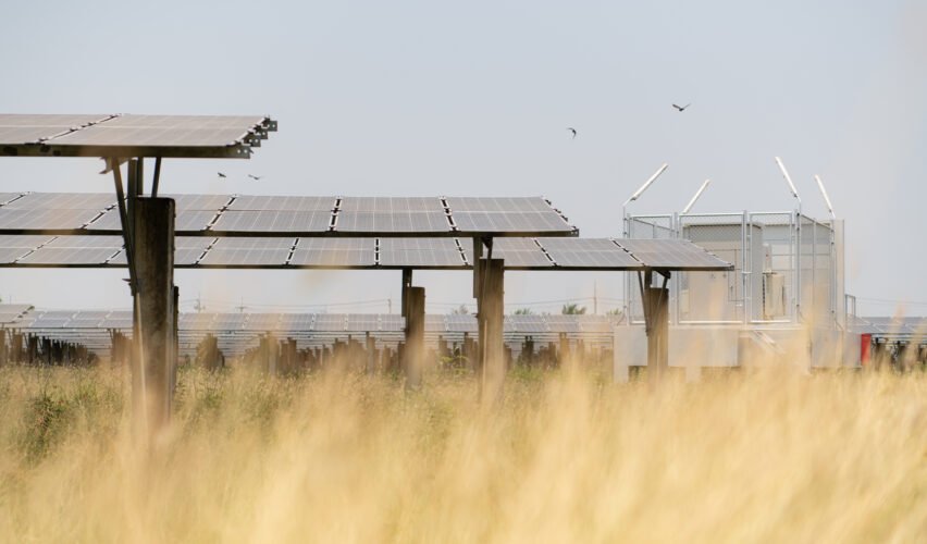 The field of solar panels with an energy storage station located in the middle of a solar cell panel on an area of hundreds of acres
